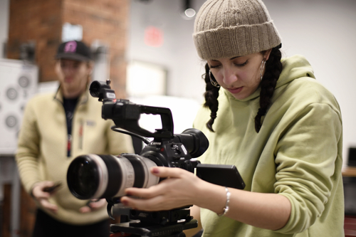 Girl in a beanie with a camera